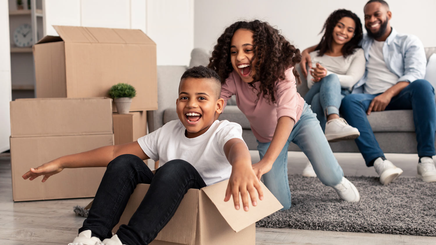 A family happily packing boxes, excited to move into a new home.